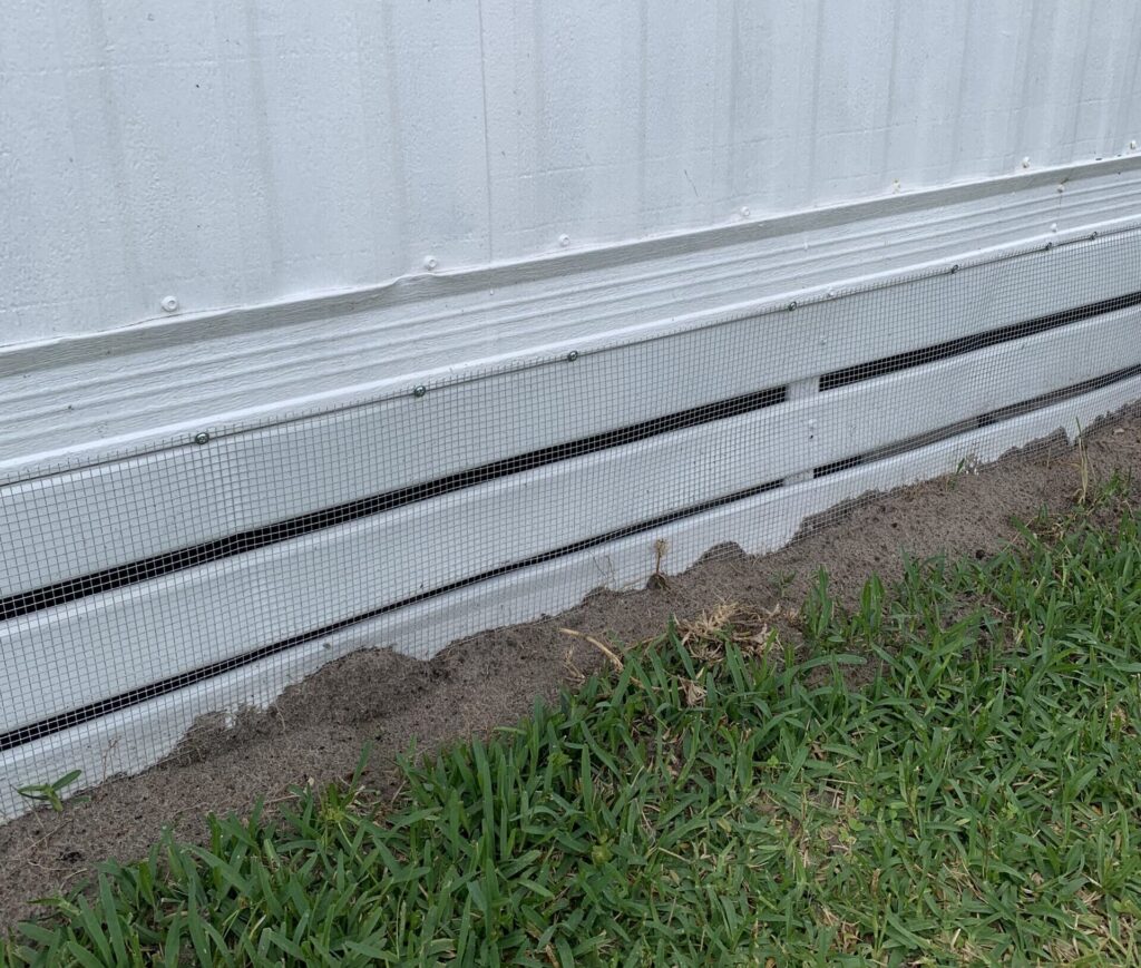 Pinellas Park mobile home with hardware cloth barrier tap‑conned into concrete foundation and sealed soffits and attic vents to prevent wildlife access