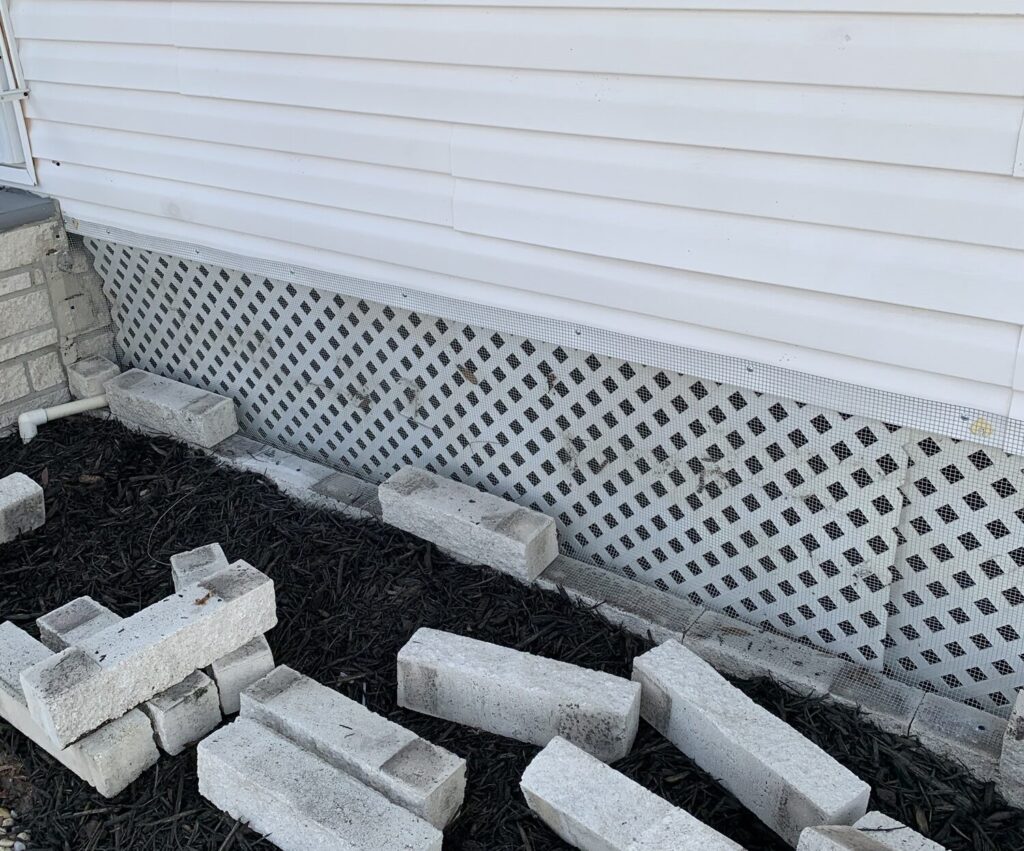 Mobile home in St. Petersburg, FL, sealed with ¼-inch hardware cloth, buried to prevent rats and wildlife from getting underneath.