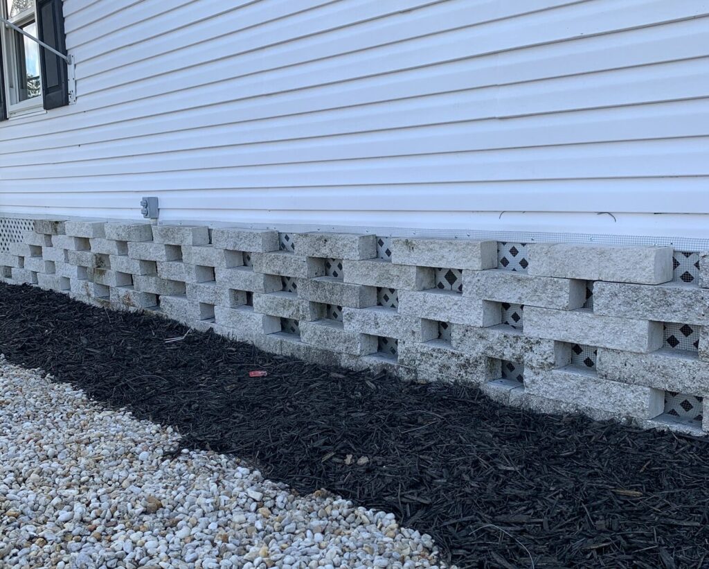 Mobile home in Brandon FL sealed with ¼-inch hardware cloth barrier to prevent wildlife intrusion beneath the home.