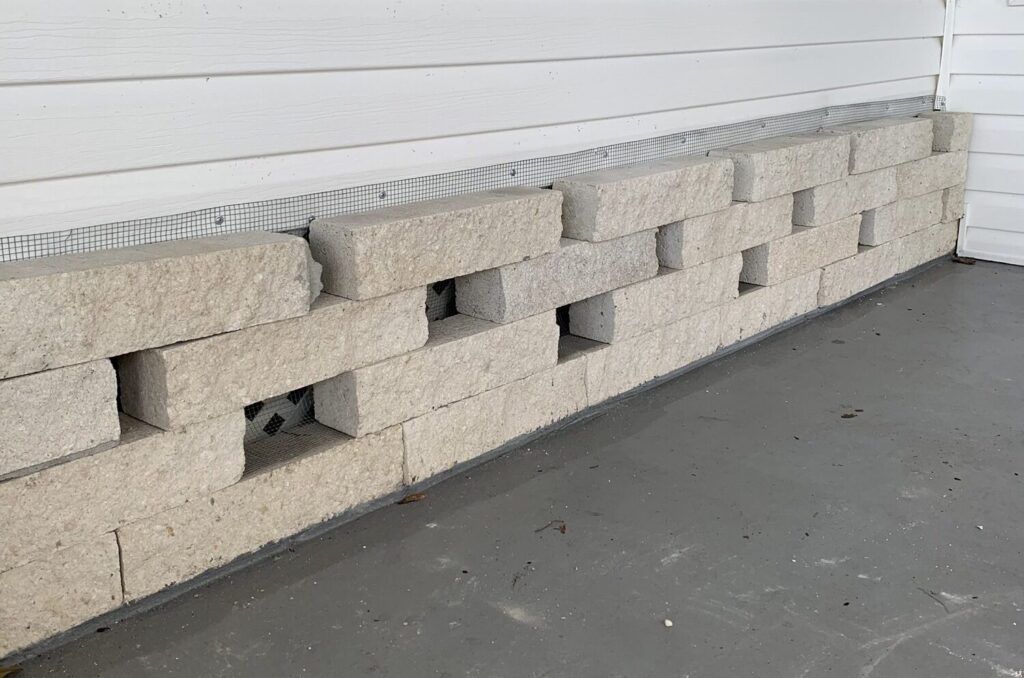 Tarpon Springs mobile home with hardware cloth barrier securely installed into concrete foundation and sealed soffits to prevent animal entry.