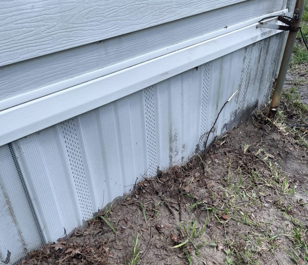 Quarter-inch hardware cloth installed around a mobile home in San Antonio to prevent wildlife entry beneath the structure.