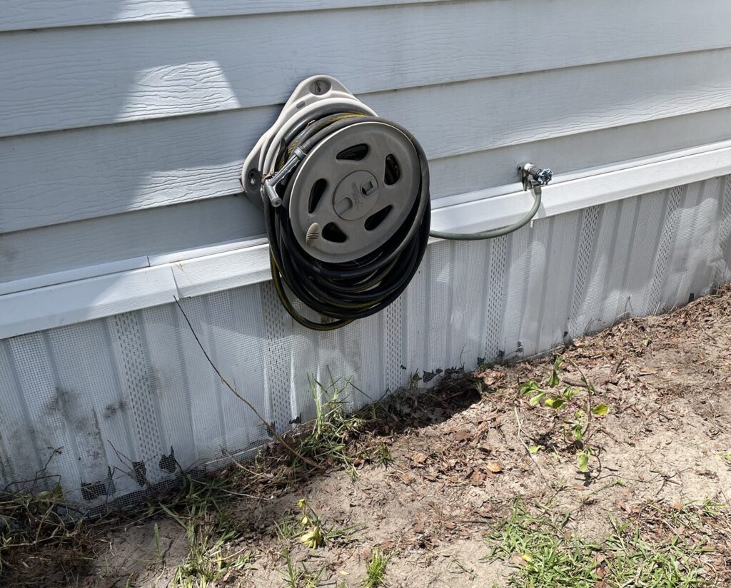 Wesley Chapel mobile home wrapped with buried ¼-inch hardware cloth to prevent rodent and wildlife access under the structure.