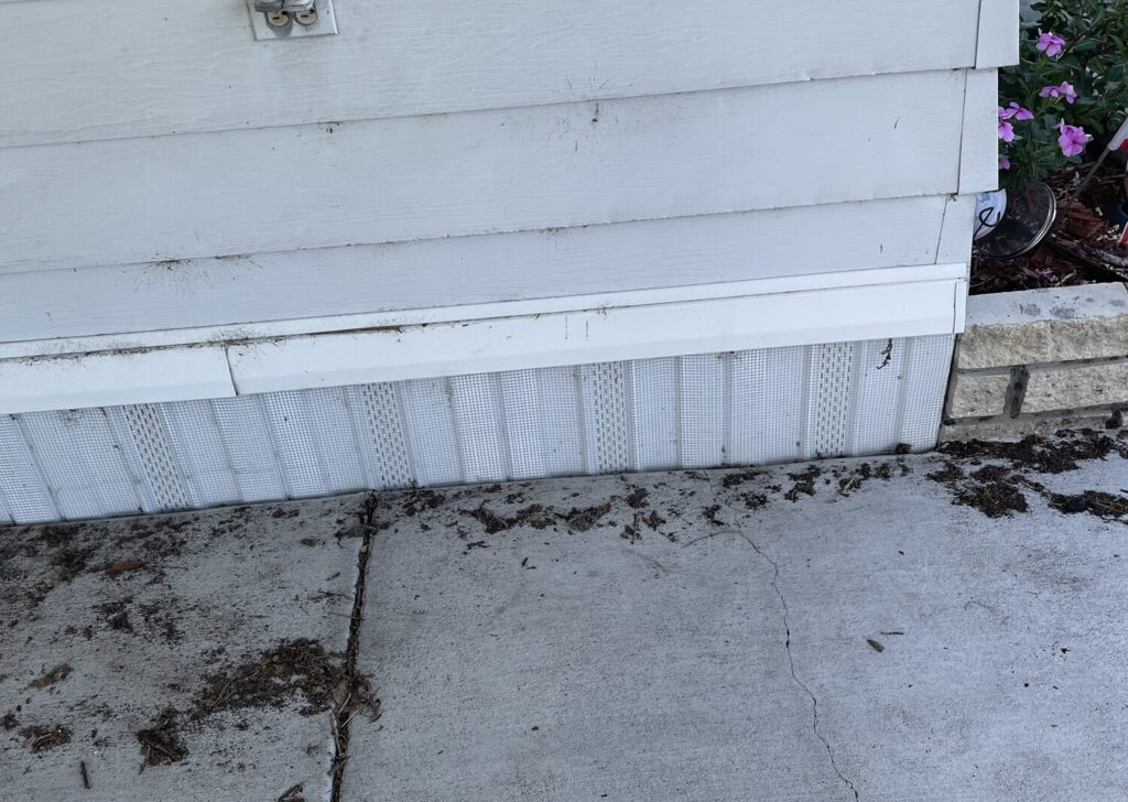 Land O Lakes mobile home fitted with buried ¼-inch hardware cloth barrier to prevent rodents and wildlife from entering underneath.