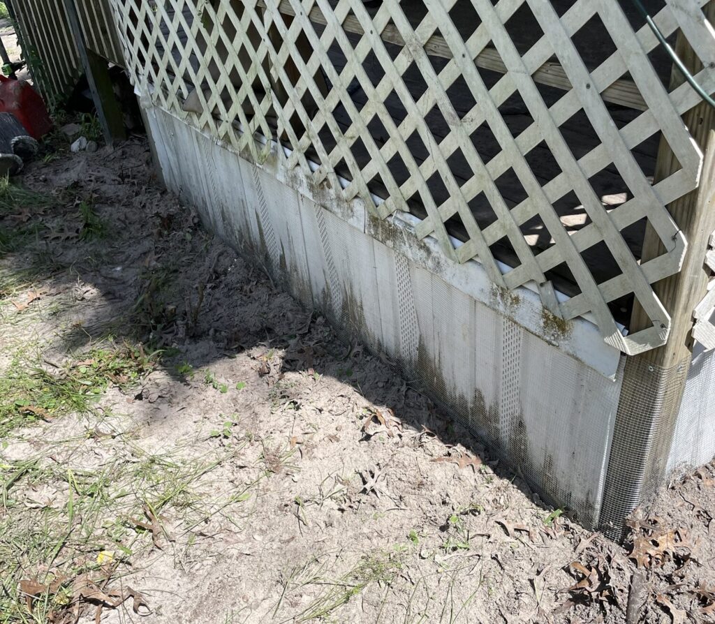 Completed Gibsonton wildlife exclusion job using professionally installed hardware cloth barriers beneath a mobile home