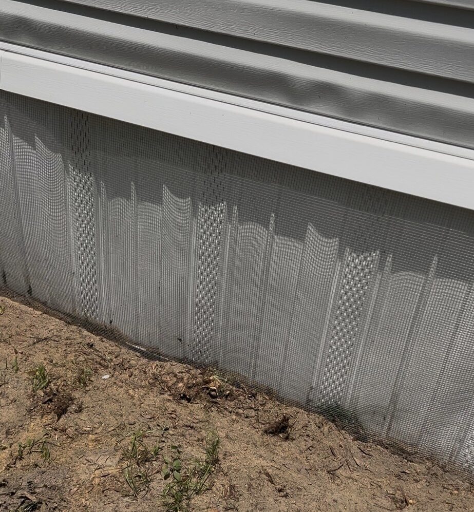 Lacoochee mobile home with hardware cloth barrier—buried or concrete‑mounted—plus sealed soffits, attic vents, and optional interior mesh wrap behind skirting.