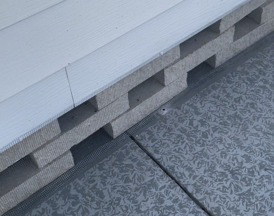 Bayonet Point mobile home with hardware cloth barrier tap‑conned into concrete foundation, attic/soffit screening, and concealed optional inside sealing to prevent wildlife entry.