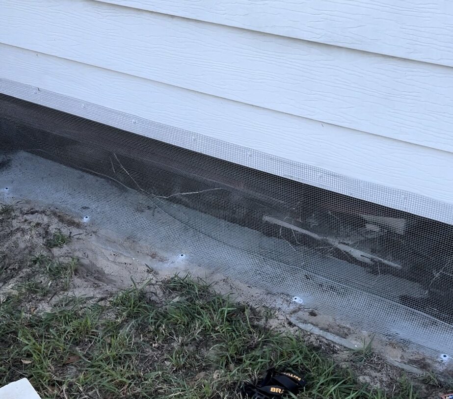 Key Vista mobile home with hardware cloth barrier (buried or concrete‑mounted) around foundation, sealed soffits and vents, and optional inside wrap behind skirting.