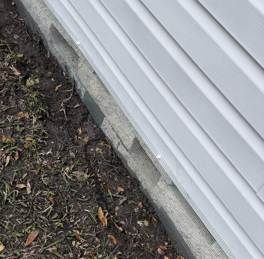 Completed wildlife exclusion beneath a Lake Magdalene mobile home using securely installed hardware cloth barriers