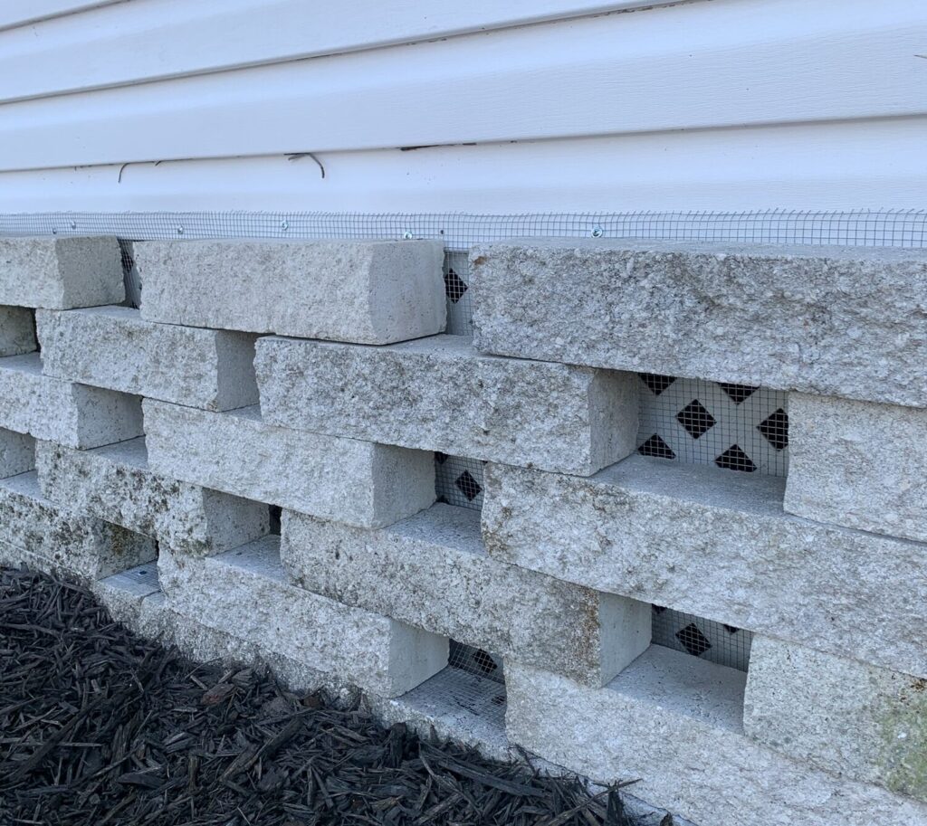 Trinity mobile home with hardware cloth barrier (buried or tap‑conned), sealed soffits and attic vents, and optional interior wrap behind skirting.