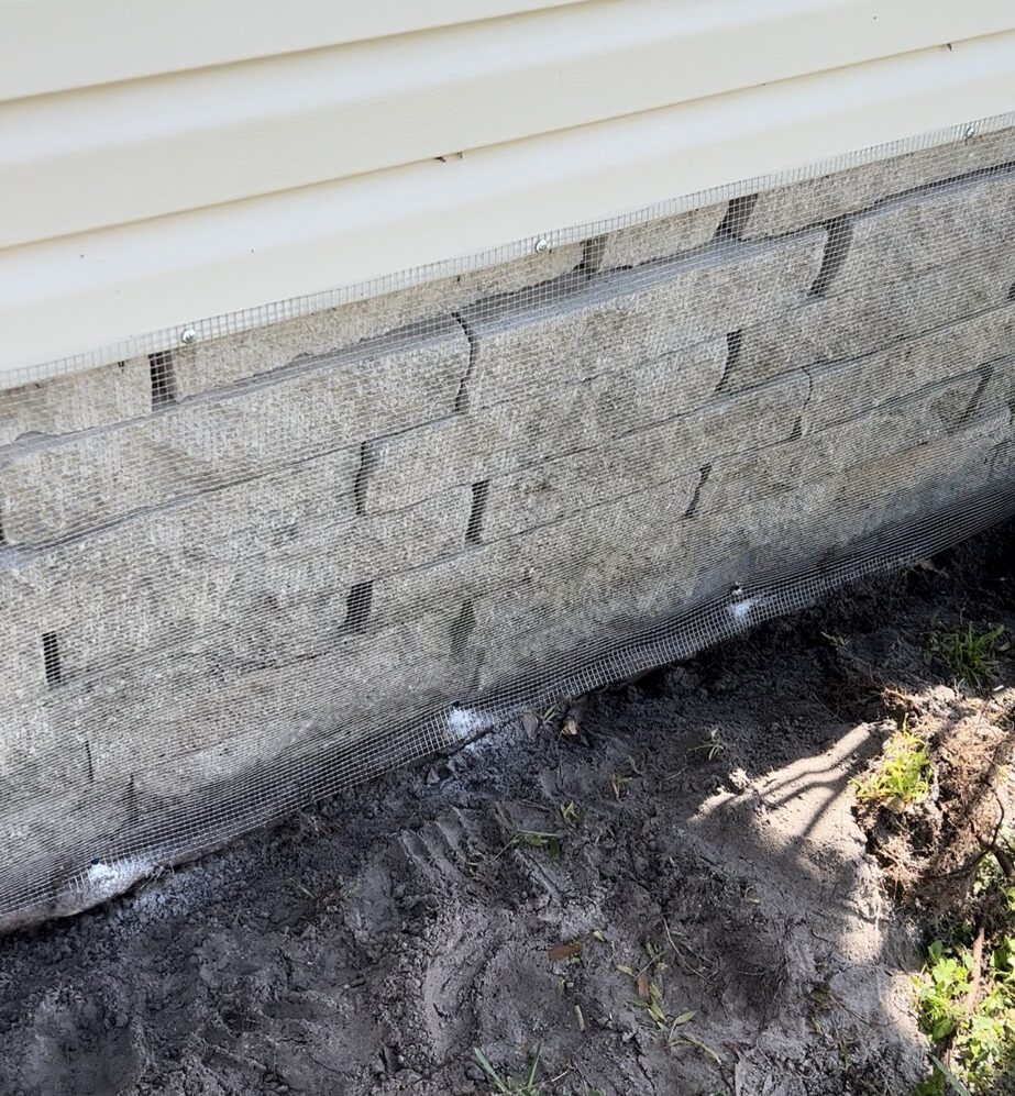 Wildlife exclusion beneath a Crystal River mobile home with ¼-inch hardware cloth barrier securely installed around ground vents and skirting.